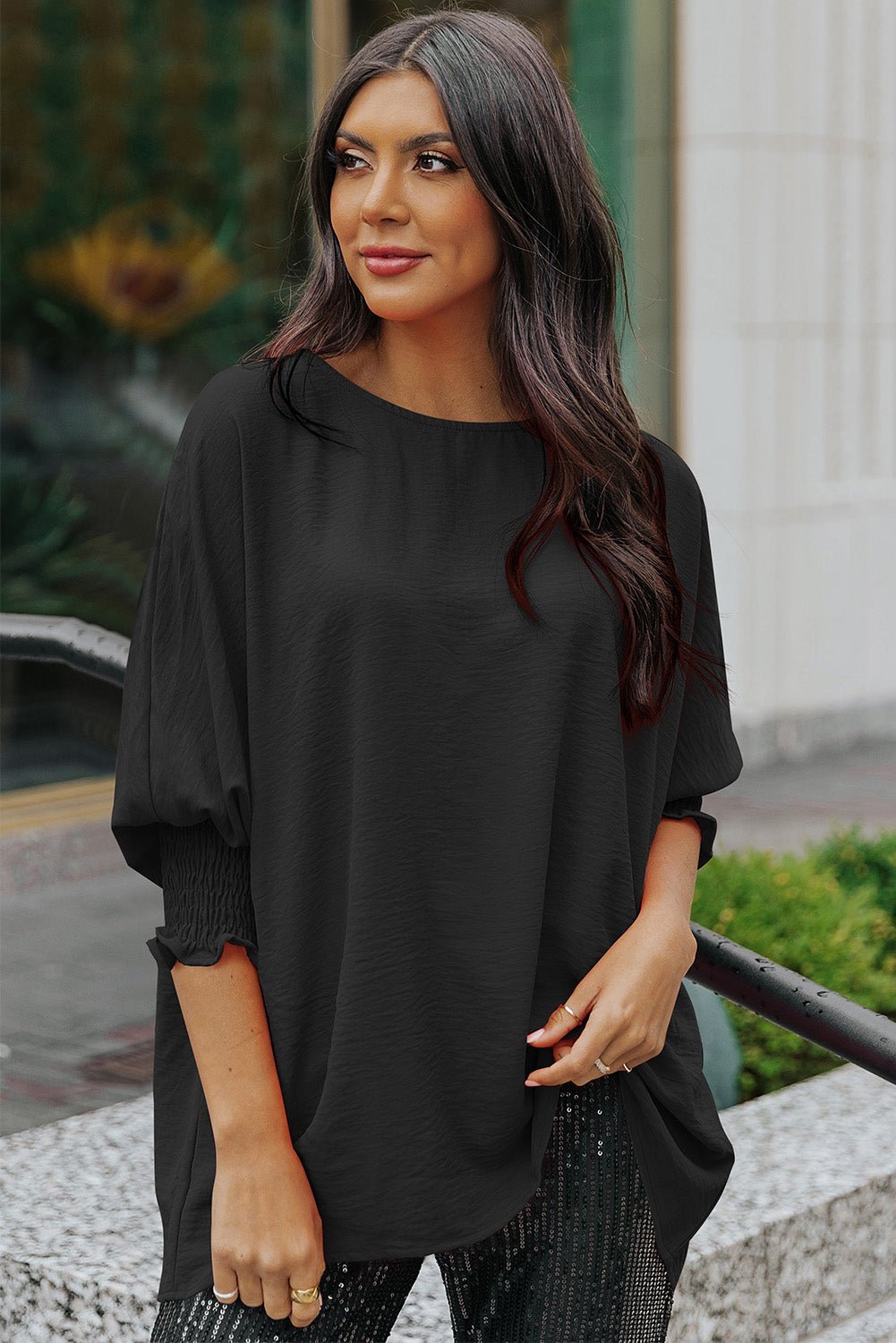 Woman wearing a black oversized top outdoors