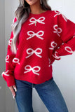 Woman in bright red knit sweater with white bow pattern and blue jeans.