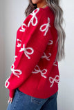 Side-back view of woman in bright red knit sweater with white fuzzy bow patterns and jeans.