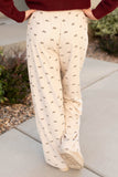 Beige pants with black pattern worn by a person outdoors.