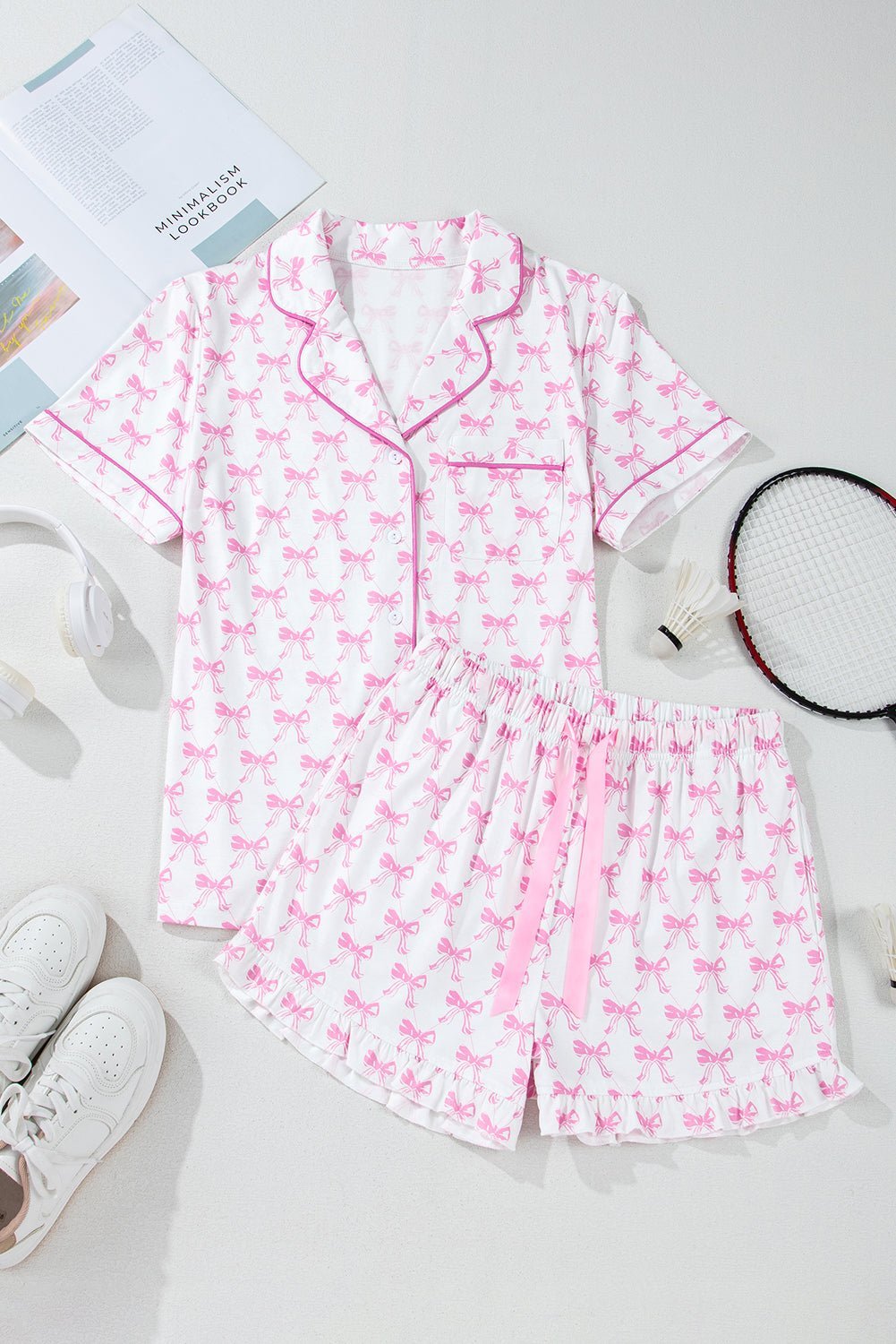 Pink pajama set with bow pattern on a light gray background