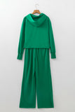 Bright green hoodie and wide leg pants set on a hanger, back view