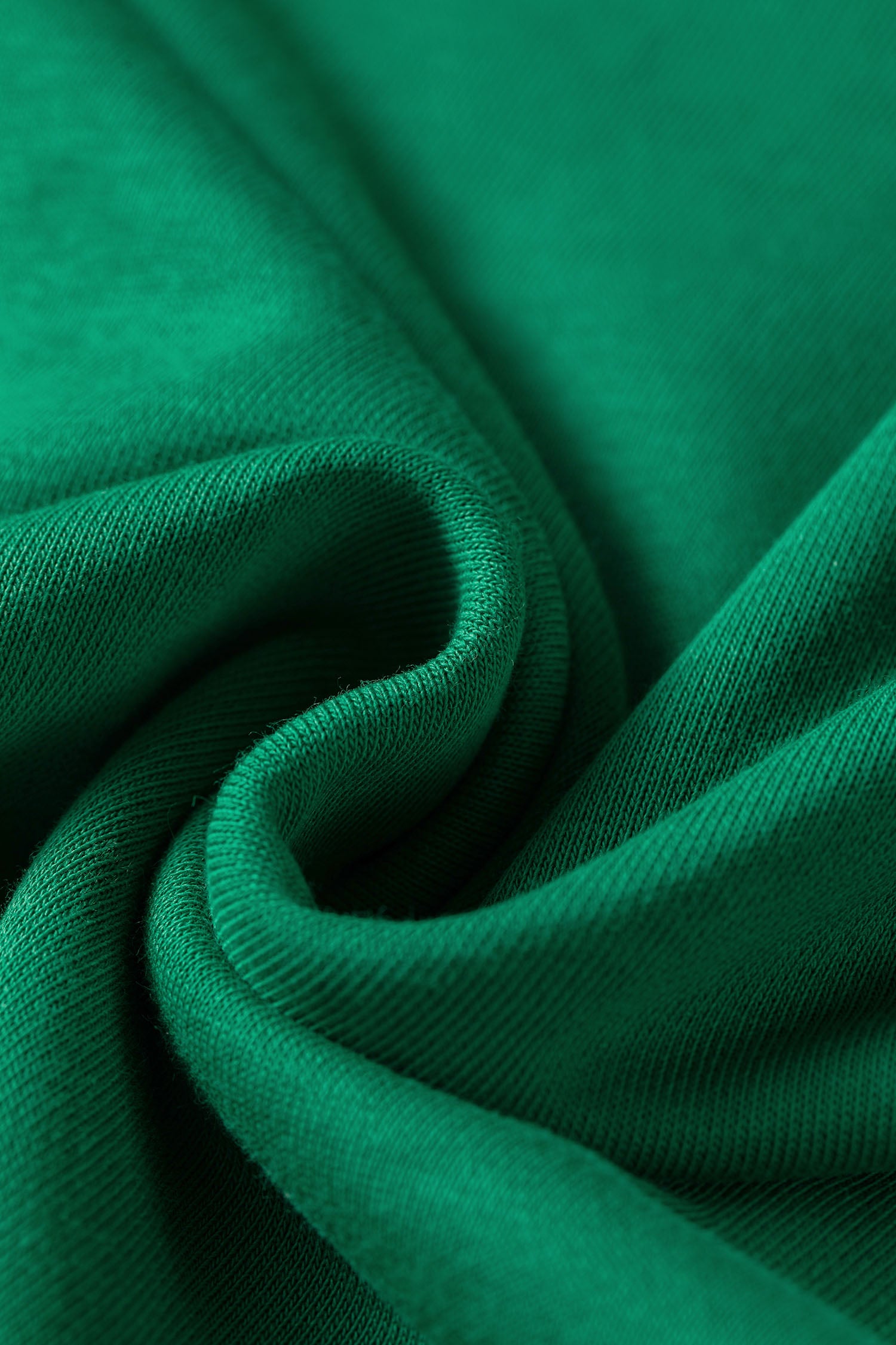 Close-up of soft bright green cotton blend sweatshirt fabric