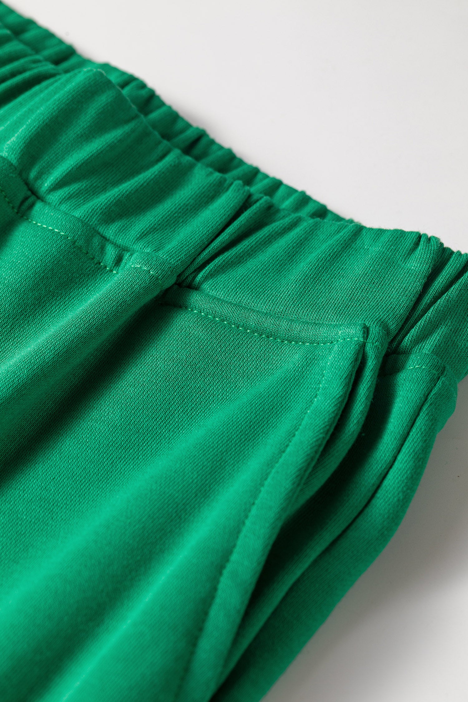 Elastic waistband detail on bright green wide leg lounge pants