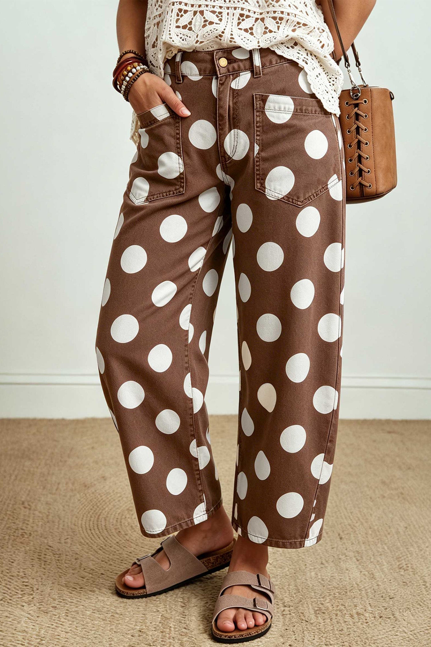 Side view of brown barrel leg jeans with large white polka dots