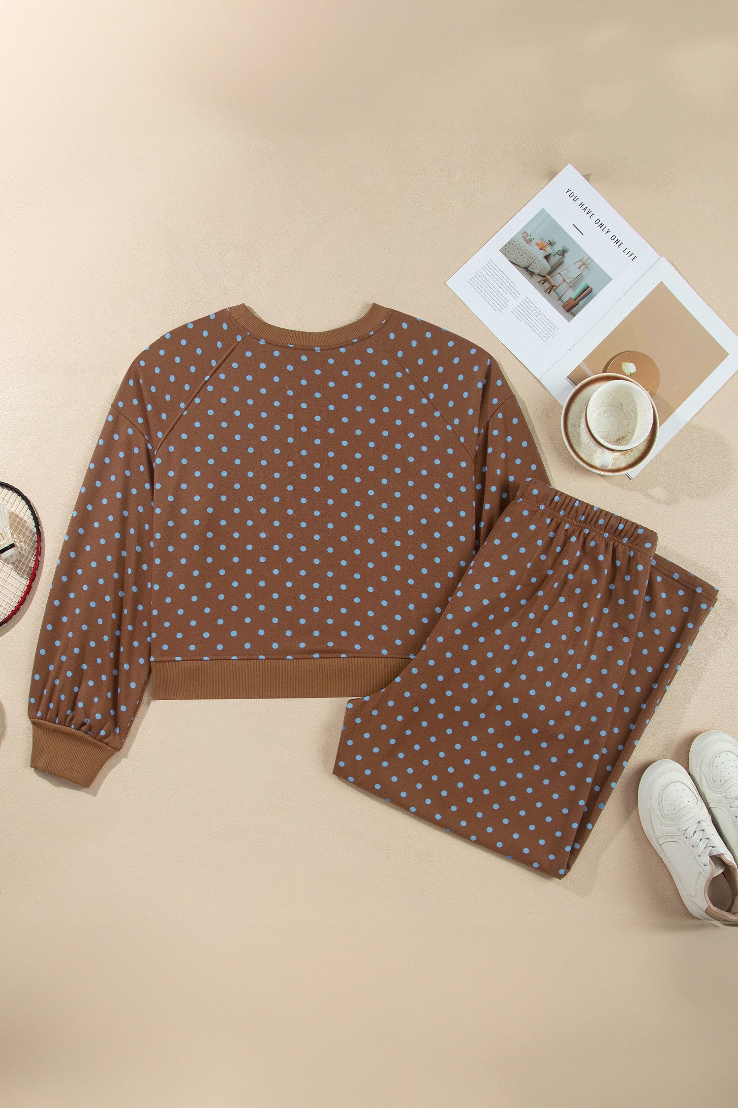 Brown polka dot top and pant set styled with coffee and sneakers