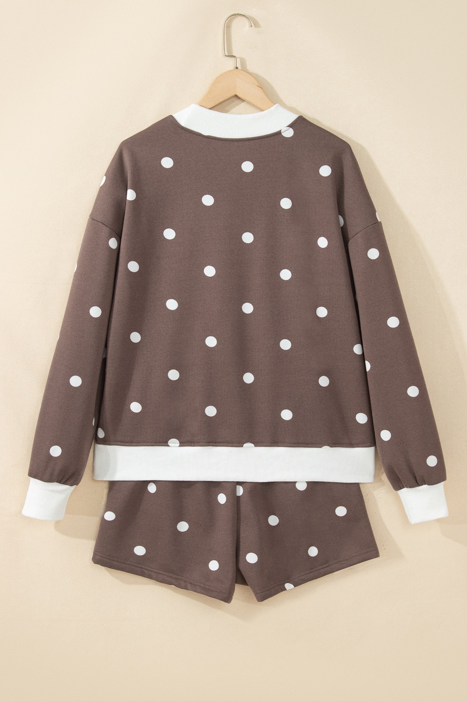 Brown polka dot top and shorts set on hanger, back view