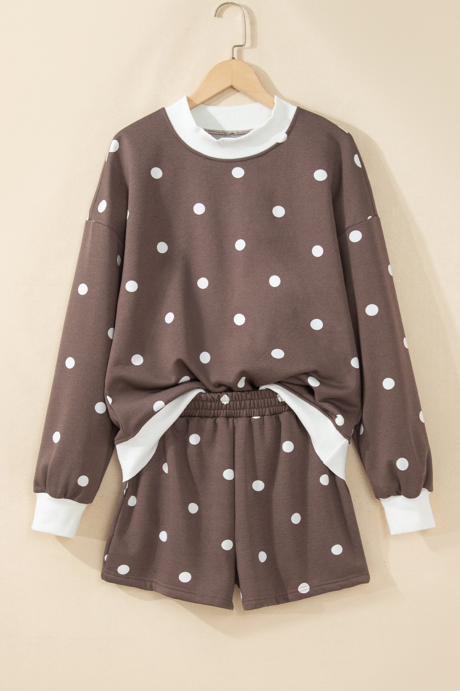 Brown polka dot top and shorts set on hanger, front view