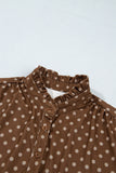Close-up of ruffled stand collar and button placket on brown polka dot dress