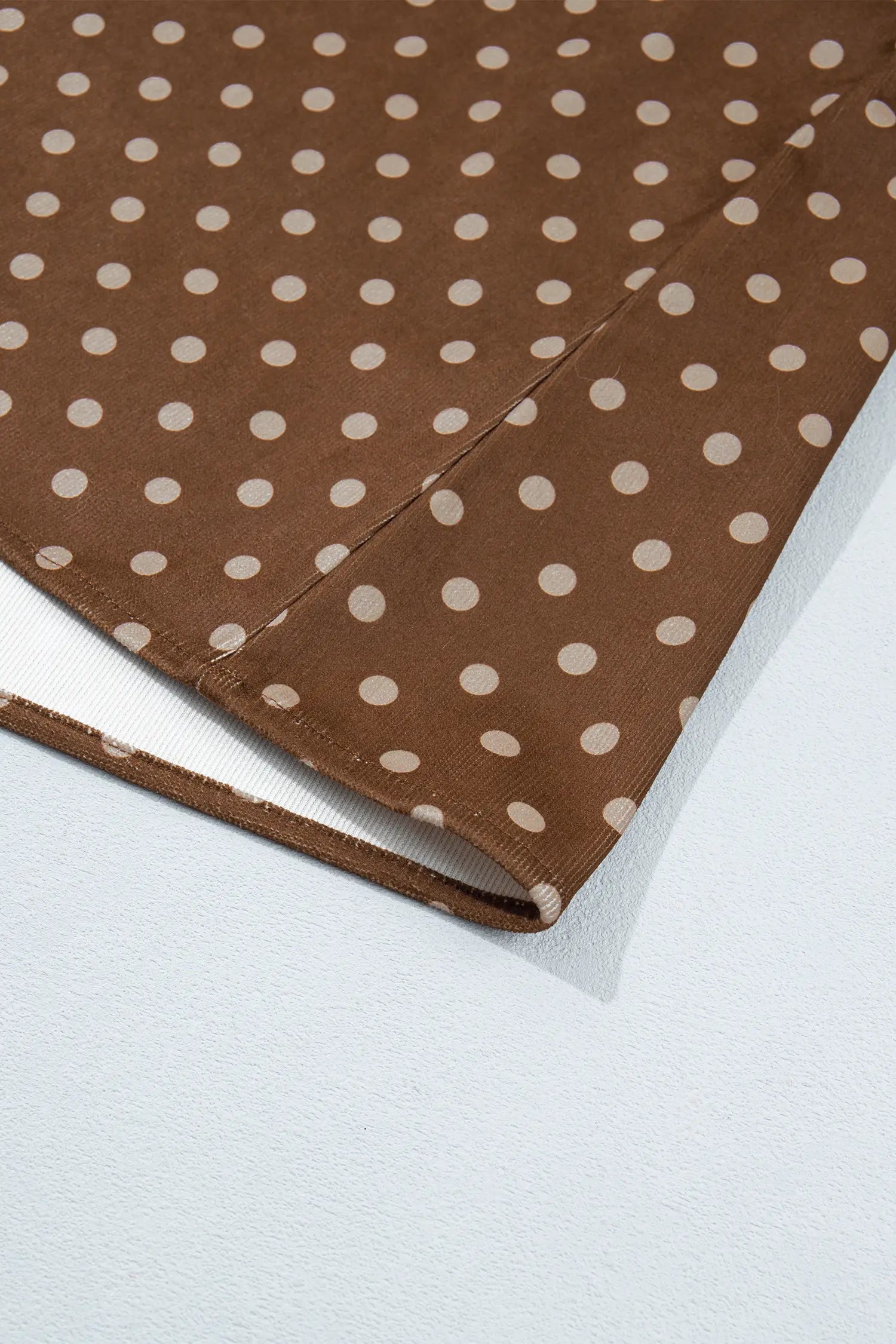 Hem detail of brown polka dot ruffle collar shift dress
