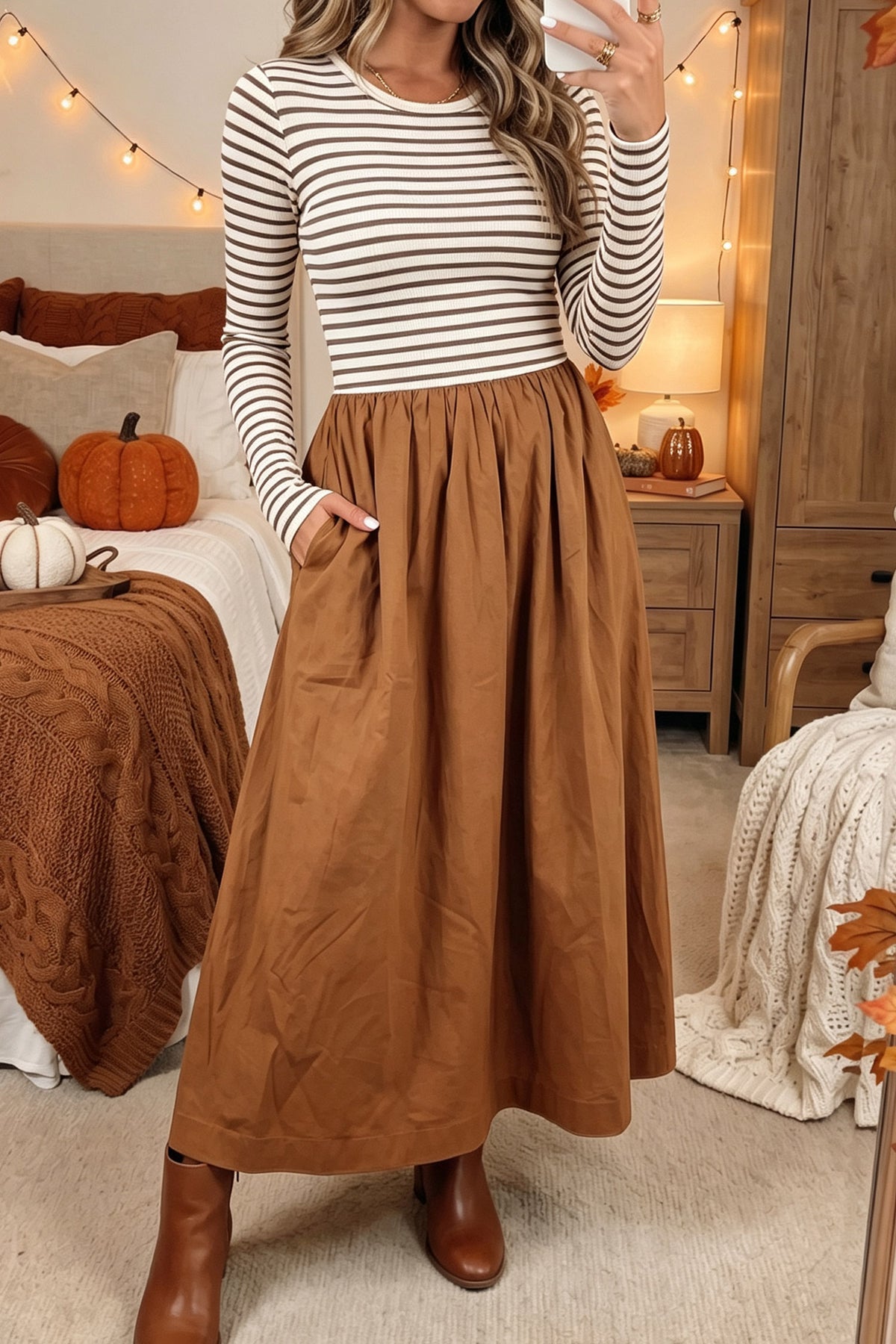 Woman wearing a brown stripe ribbed bodice long sleeve maxi dress with ankle boots