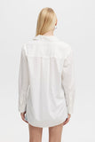 Person wearing a white shirt on a plain background
