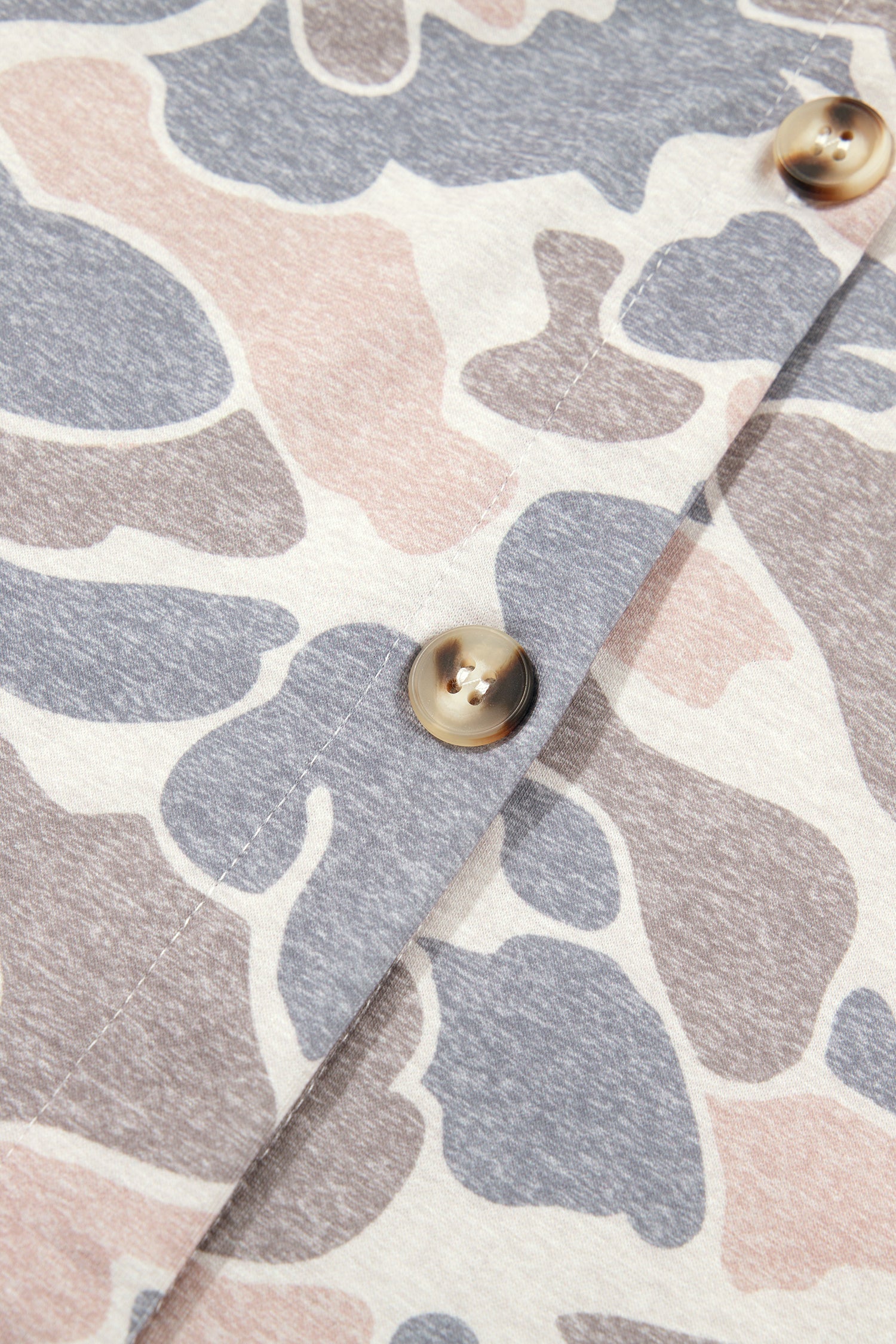 Pink and grey camo shacket button placket close-up