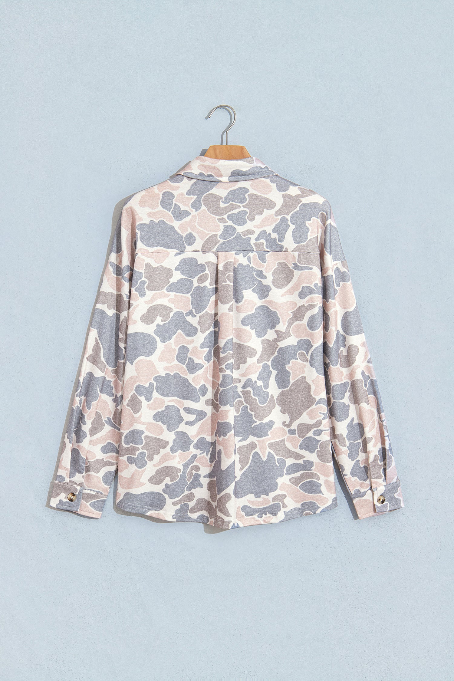 Pink and grey camo tunic shacket with back yoke on a hanger, back view