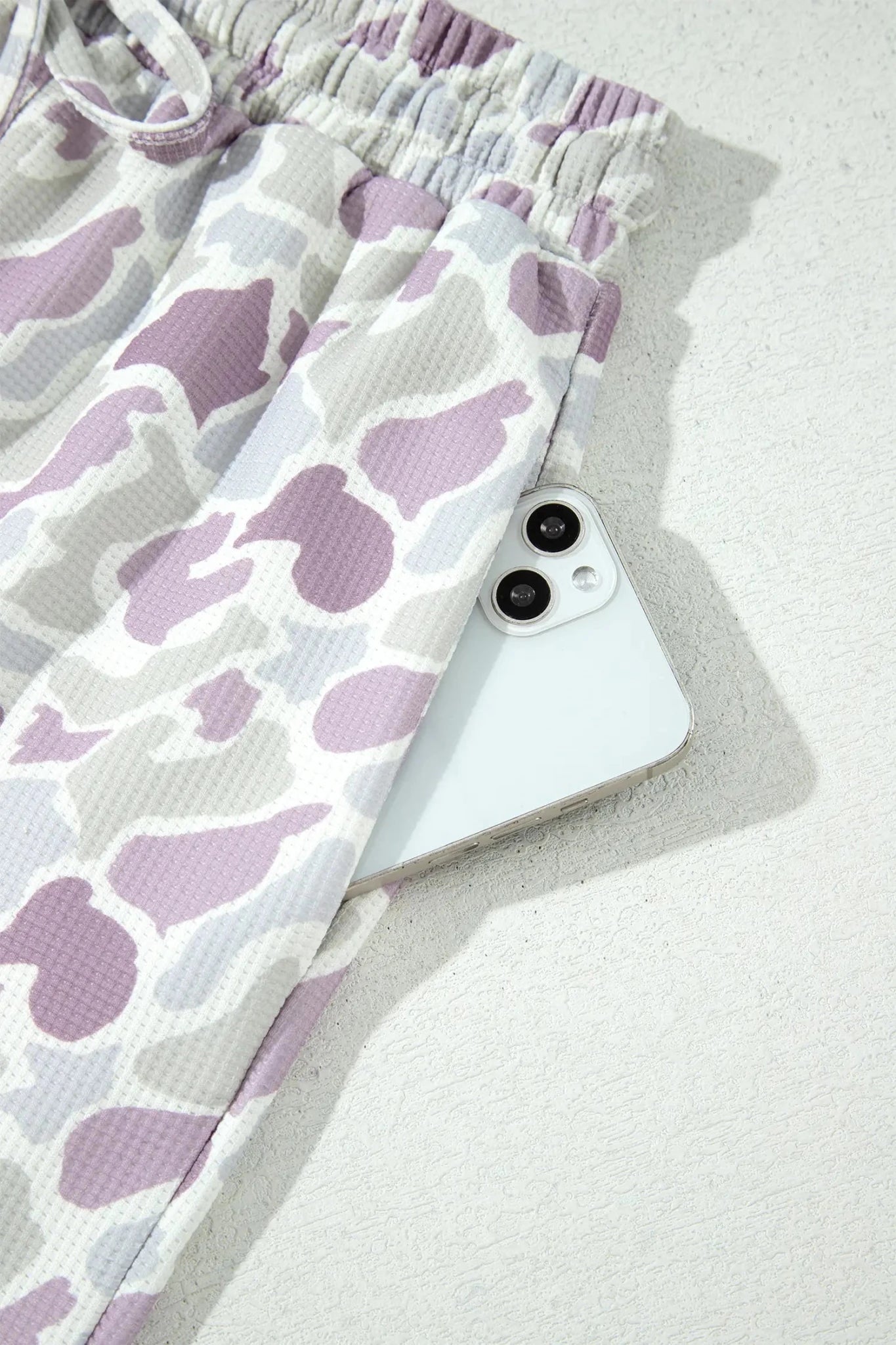 Purple and white abstract cow-print waffle-textured lounge pants.