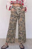 Women's camo print drawstring waist wide leg jeans with patch pockets and sandals, front view
