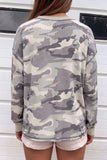 Back view of person in gray-beige camo waffle-knit sweatshirt and pink shorts.
