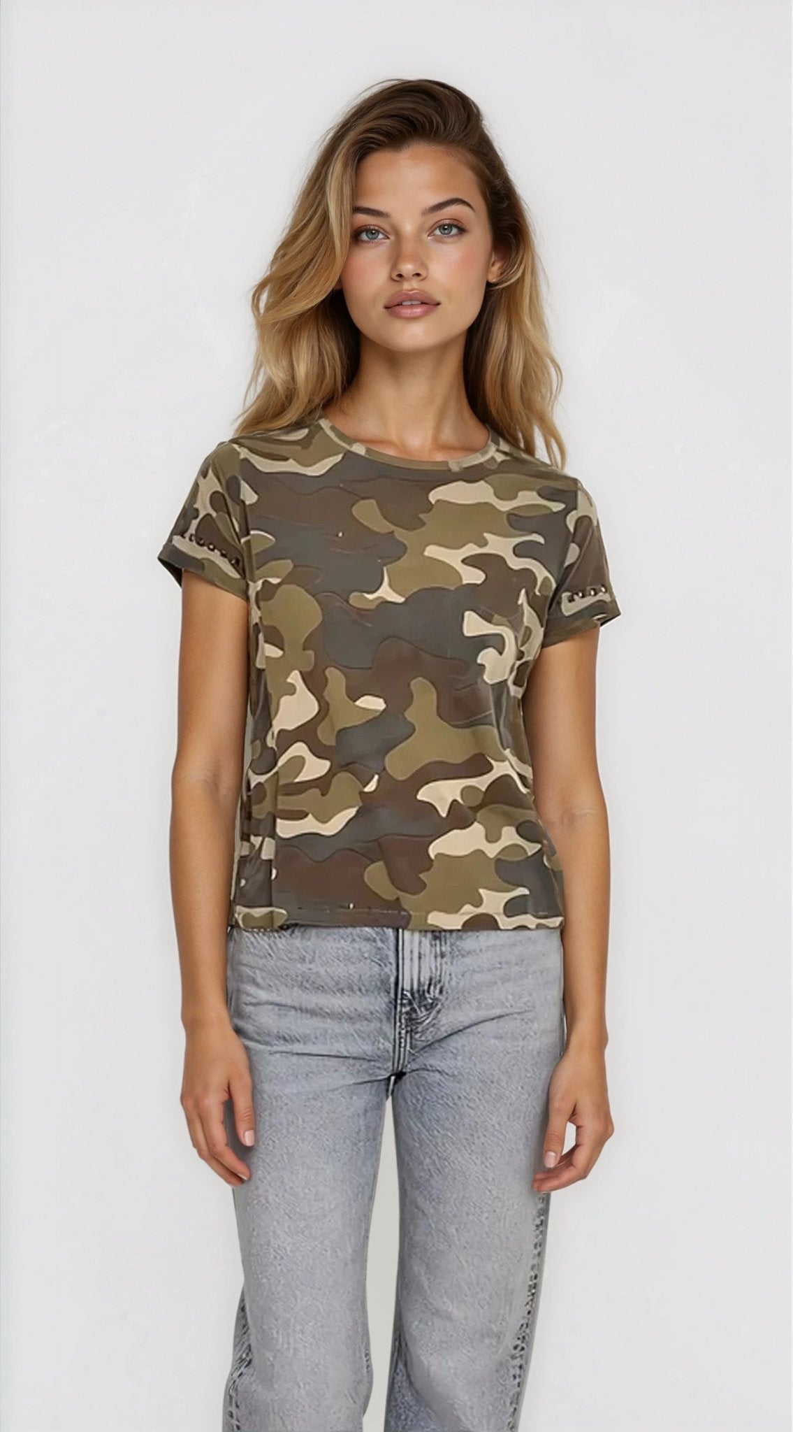 Woman wearing a camouflage t-shirt and light blue jeans on a white background