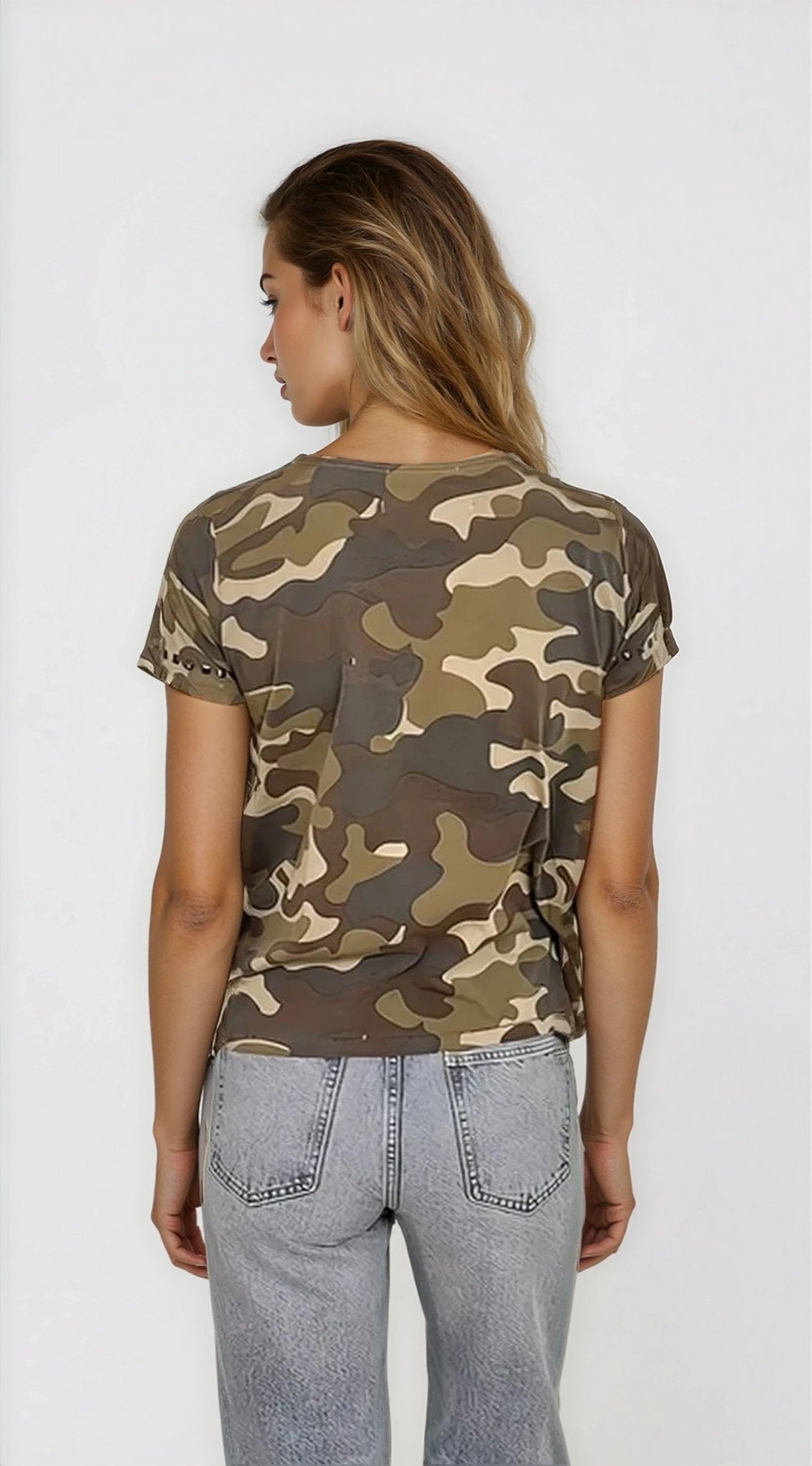 Person wearing a camouflage t-shirt and light blue jeans on a white background