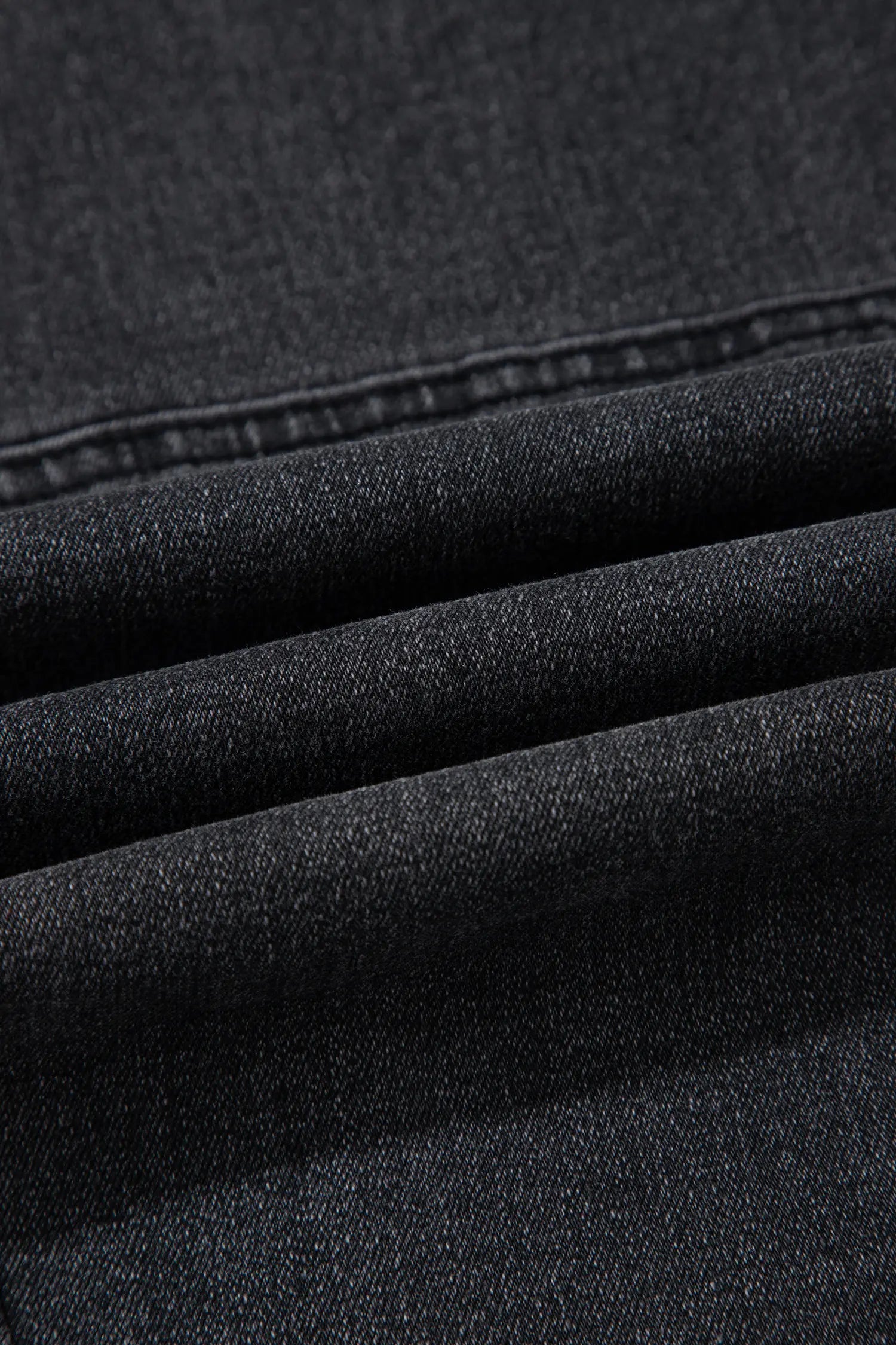Close-up of carbon grey stretch denim fabric