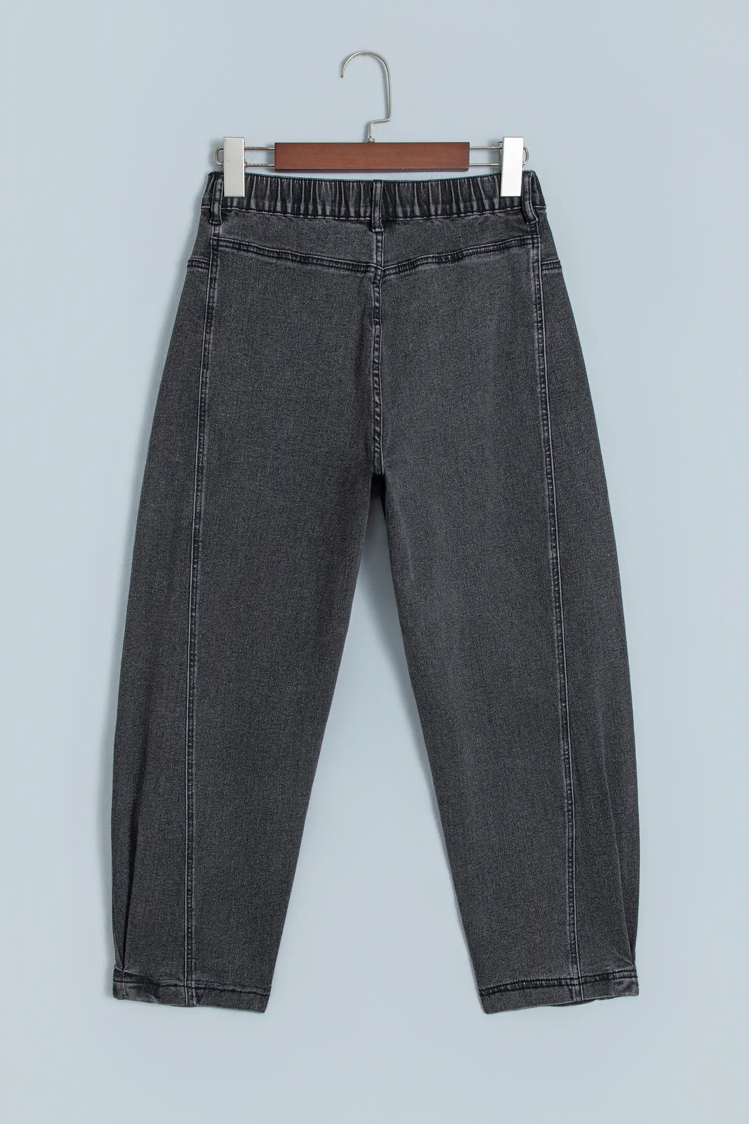 Carbon grey barrel leg jeans with elastic back waistband on a hanger, back view
