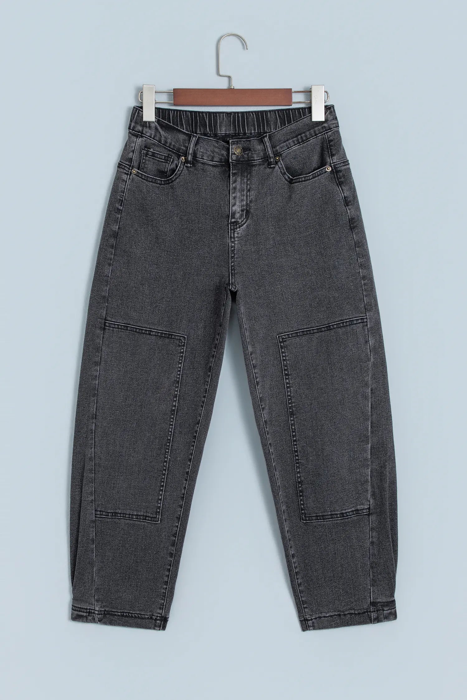 Carbon grey barrel leg patchwork jeans on a hanger, front view