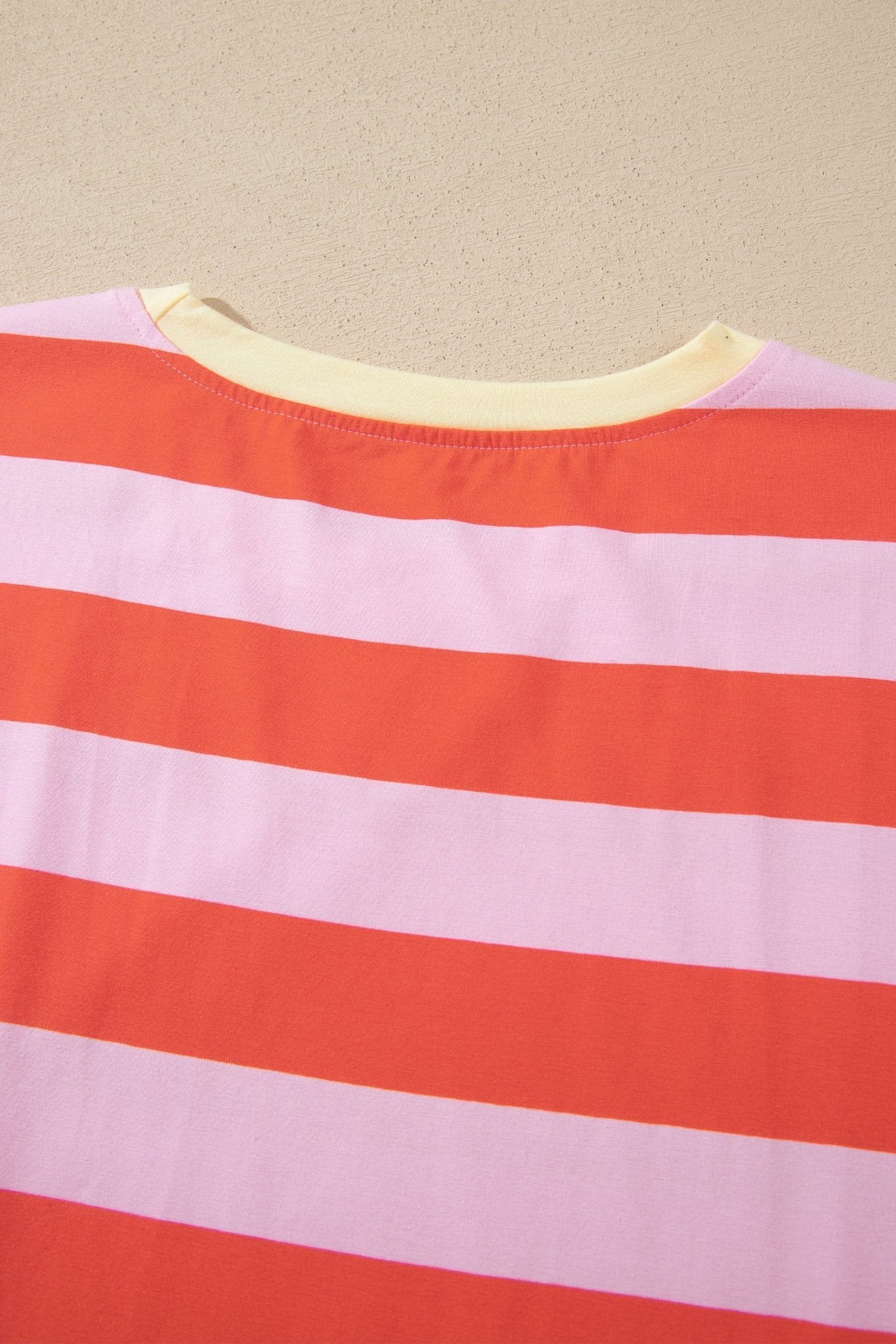 Orange and light pink striped top with cream inner collar.