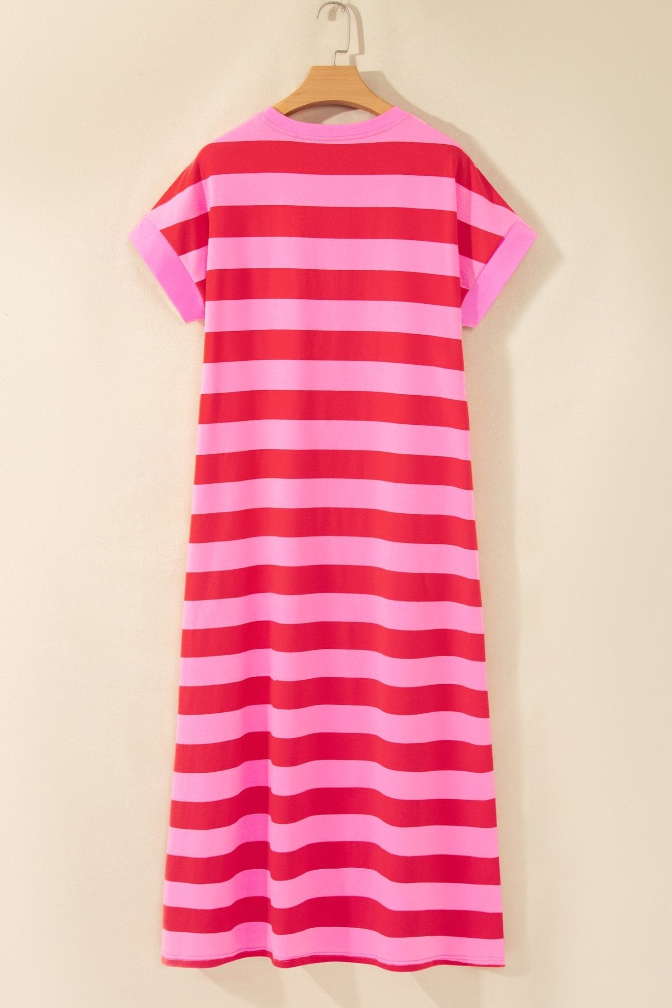 Pink and red striped short-sleeve dress on wooden hanger.