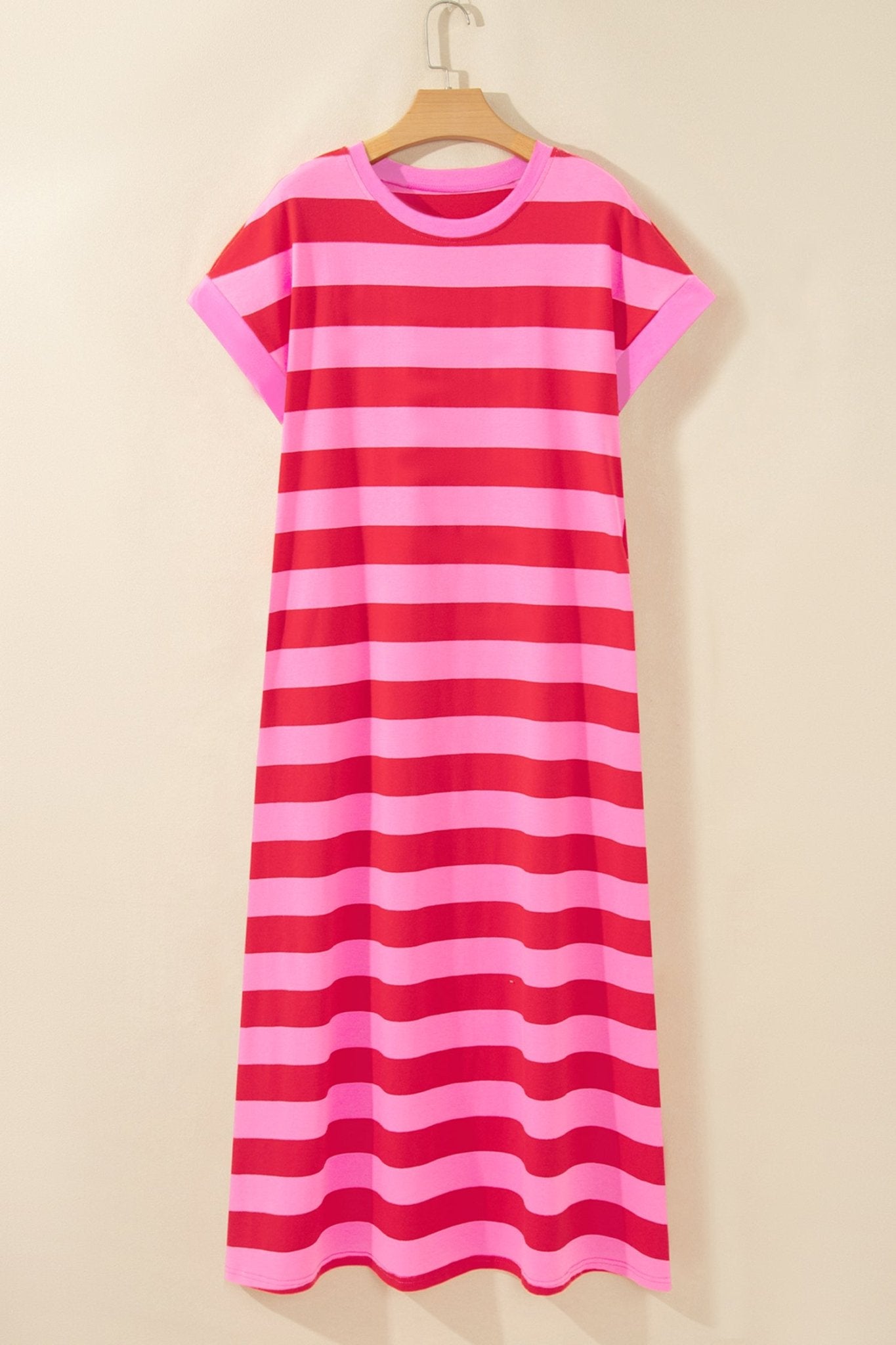 Pink and red striped short-sleeve dress on wooden hanger.