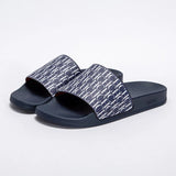 Pair of black slides with a patterned strap on a white background