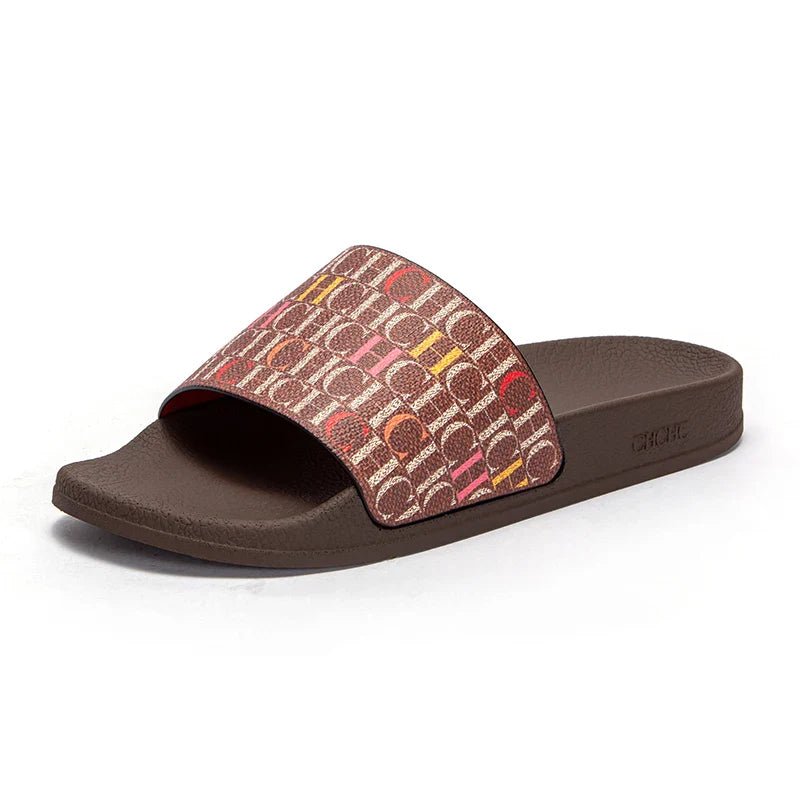 Brown slide sandal with patterned strap on a white background