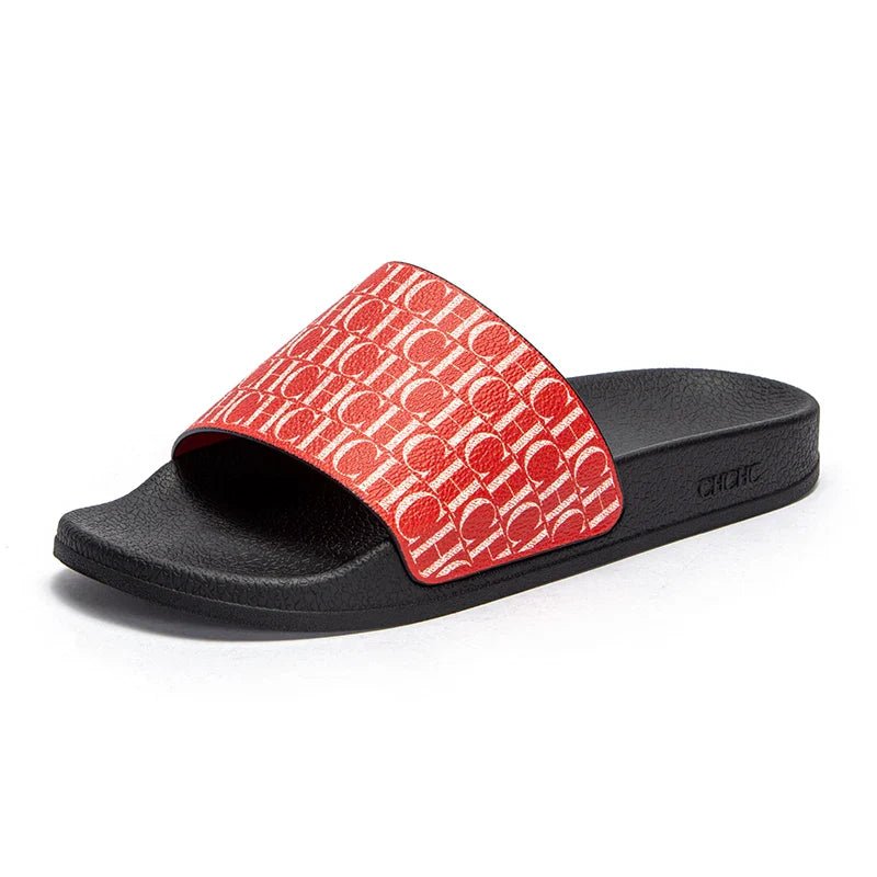 Black slide sandal with a red patterned strap on a white background