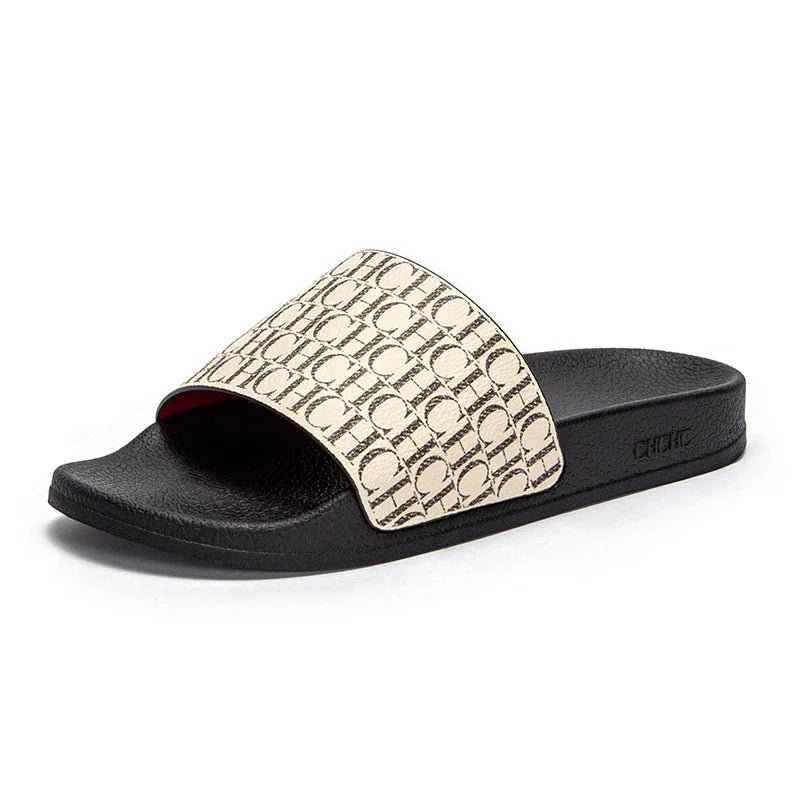 Black slide sandal with beige patterned strap on a white background