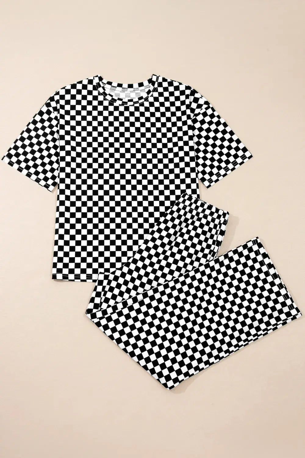 Black and white checkered shirt and shorts set on a beige background