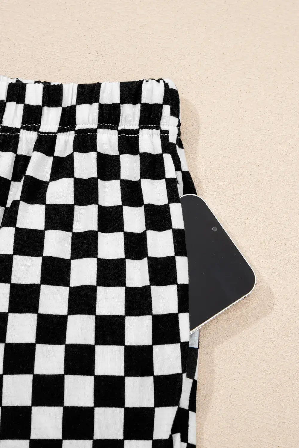 Black and white checkered fabric on a beige background