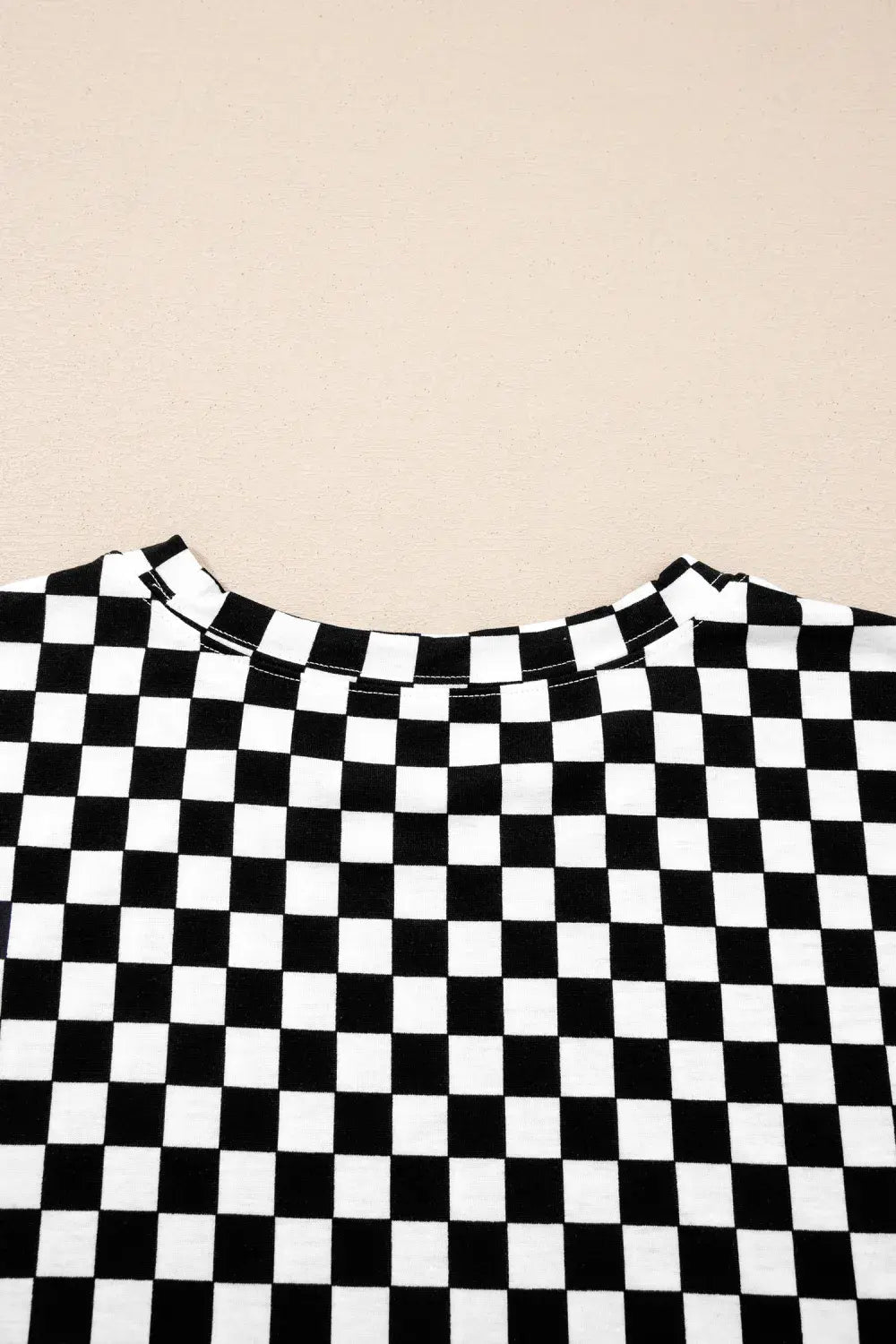 Black and white checkered pattern on a beige background