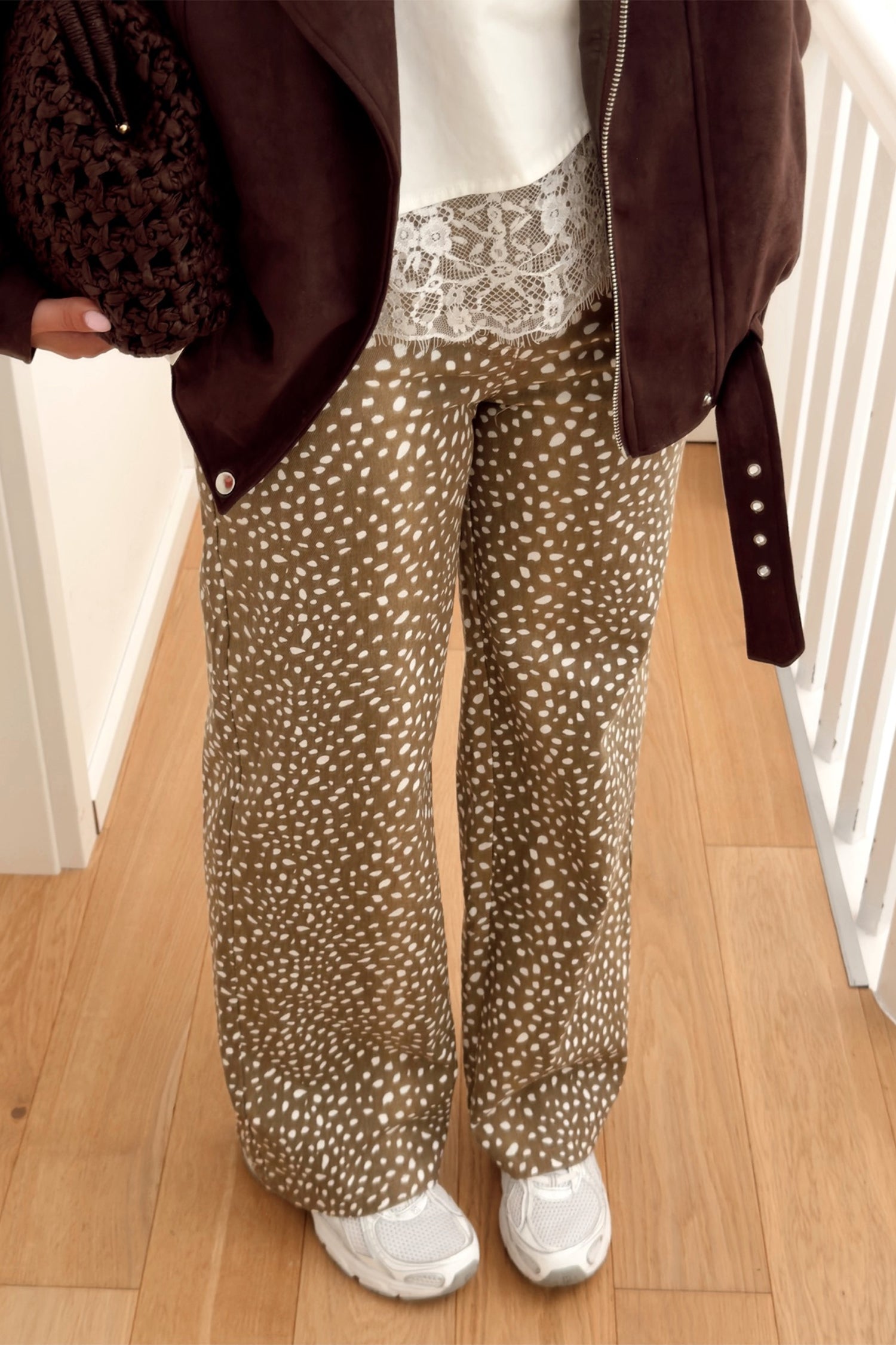 Brown cheetah print wide leg jeans with lace cami and leather jacket