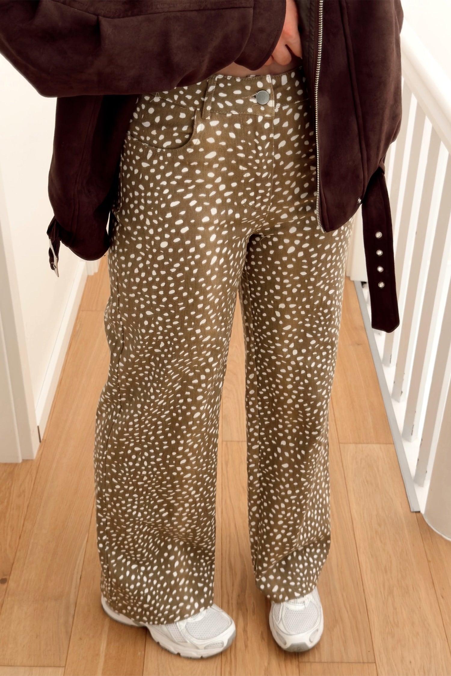 Brown cheetah print full length wide leg jeans, hand in pocket front view