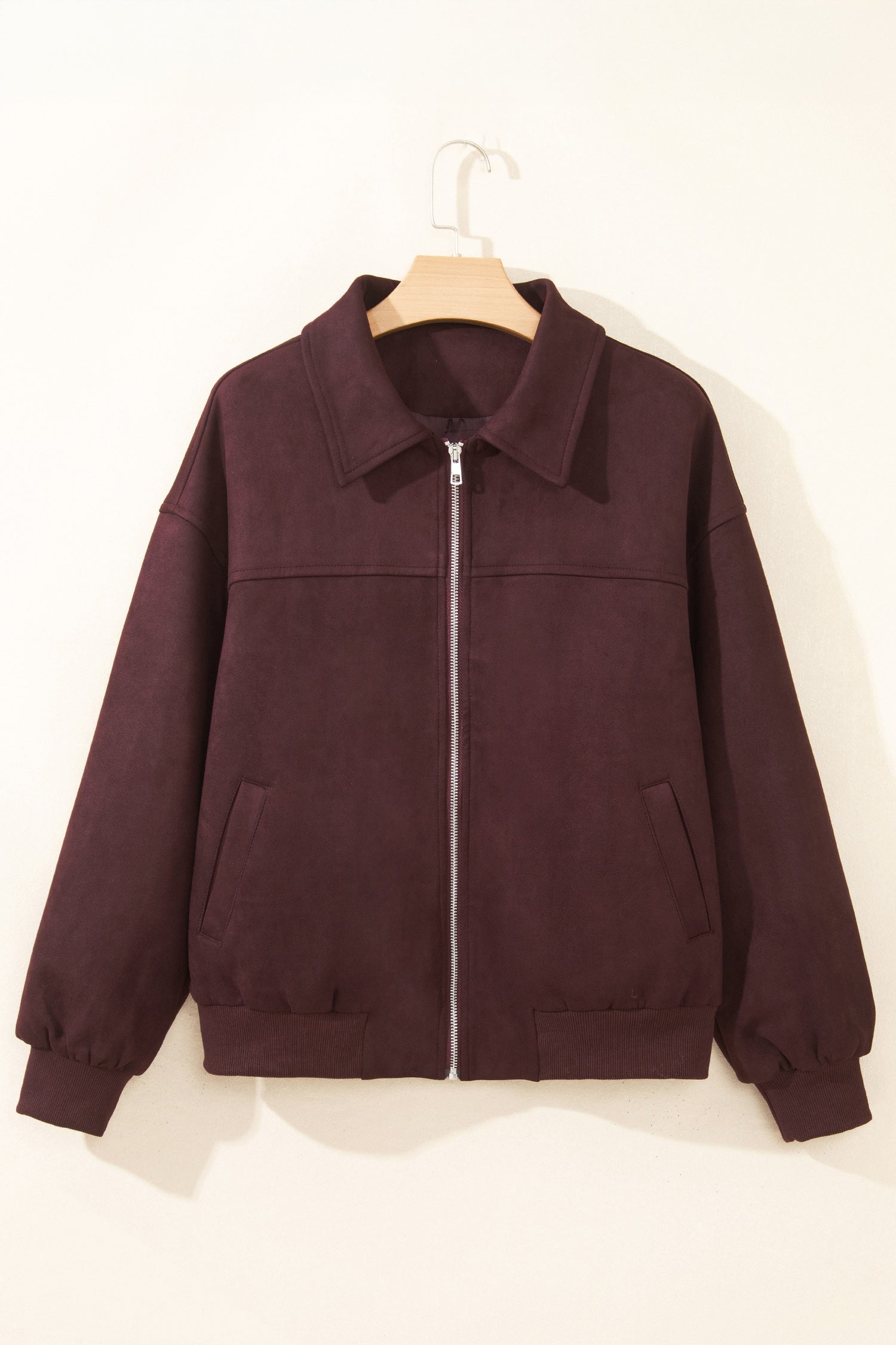 Chicory coffee collared bomber jacket with metal zip and side pockets on a hanger