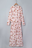 Light pink pajamas with gingerbread, cinnamon sticks, and heart print on hanger.