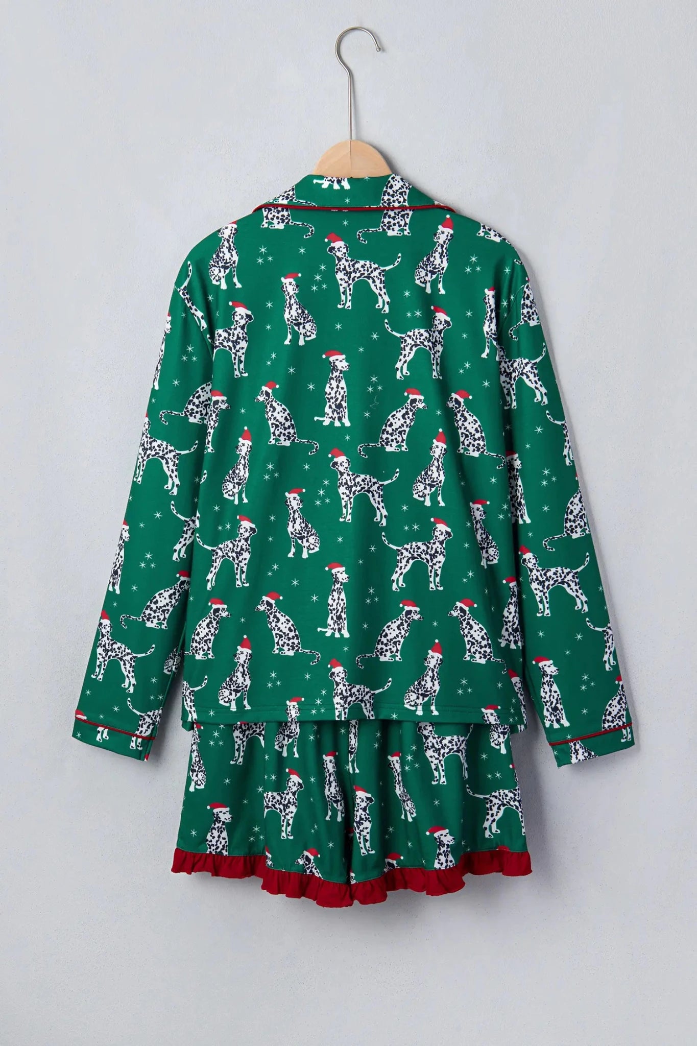 Green Dalmatian pajama set with button-up top and ruffled skirt.