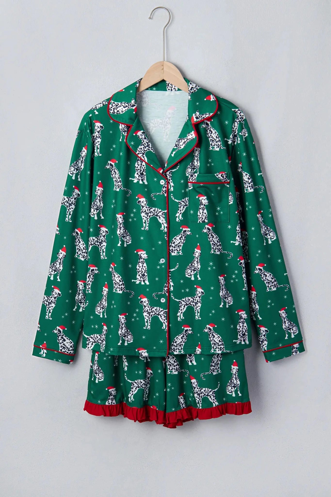 Green Dalmatian Christmas pajama set with red piping and ruffled hem.