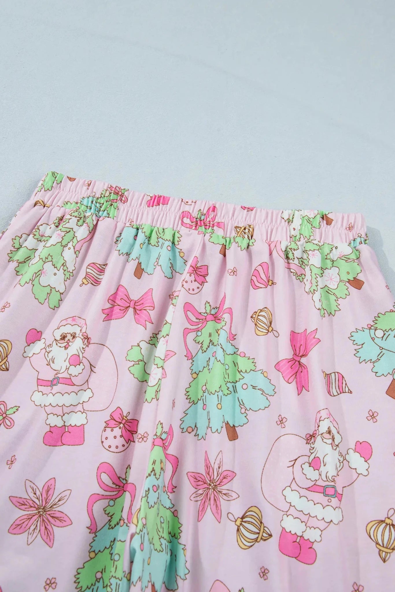 Pink sleep pants with a festive Christmas print.