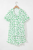 Green shamrock patterned pajama set on a hanger against a white background