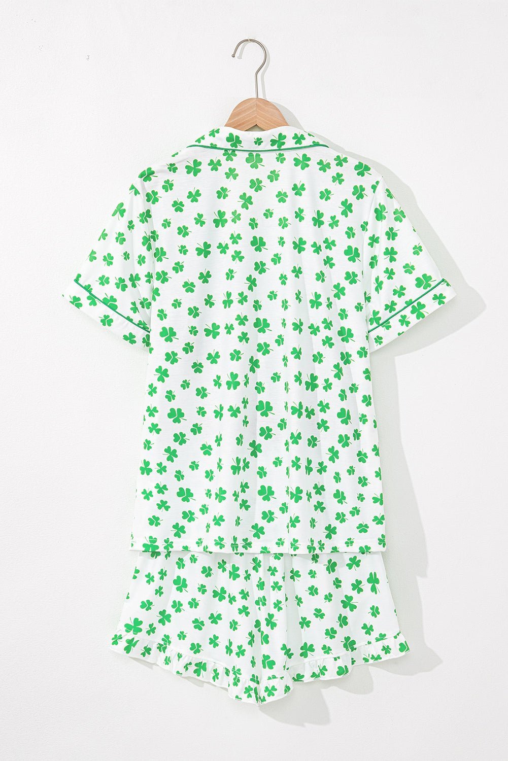 White nightshirt with green shamrock pattern on a white background