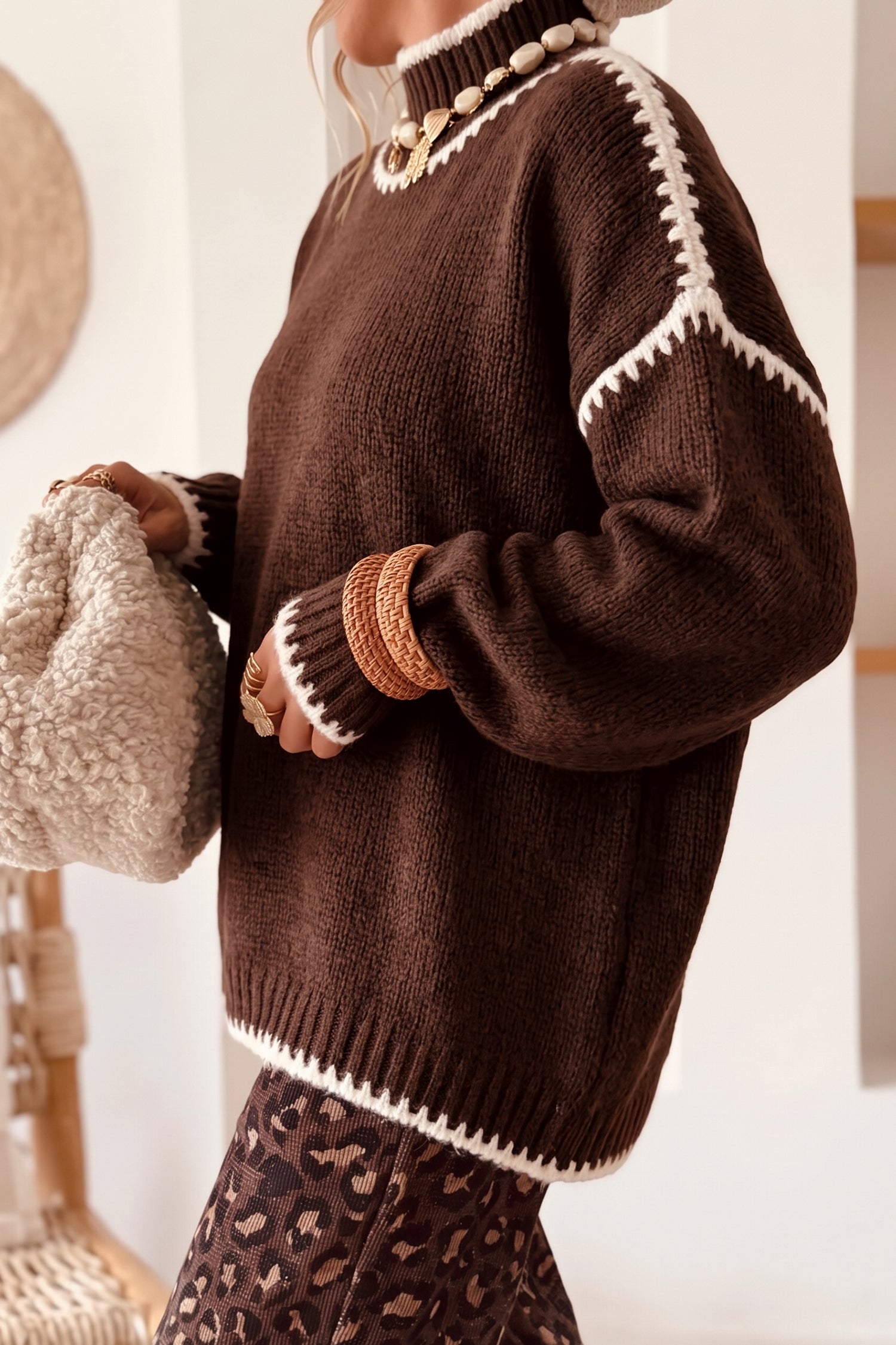 Side view of coffee brown drop shoulder sweater with cream contrast stitching