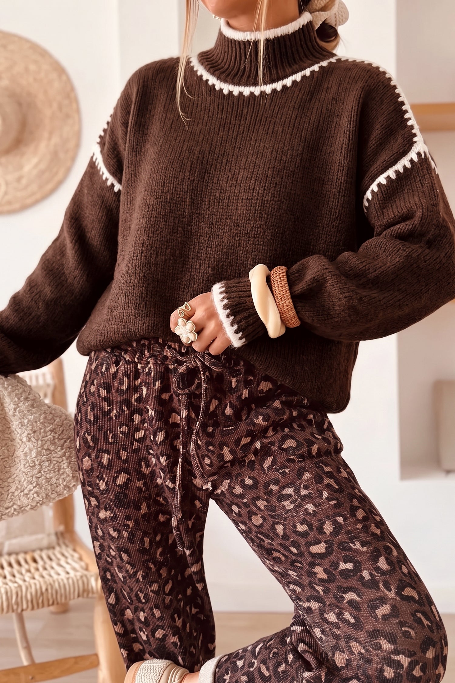 Coffee brown contrast stitch mock neck sweater styled with leopard print pants