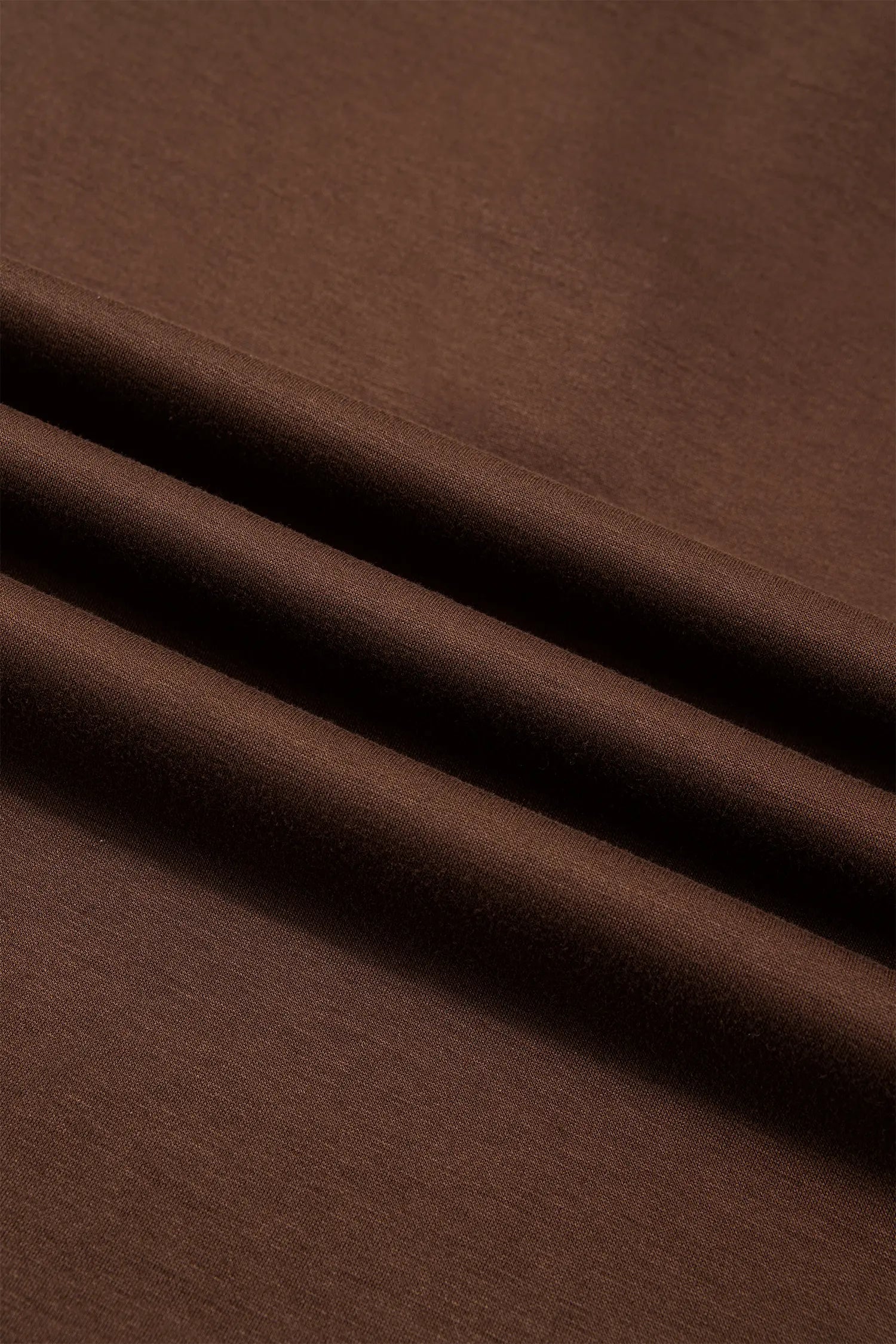 Close-up of soft, smooth coffee brown knit fabric