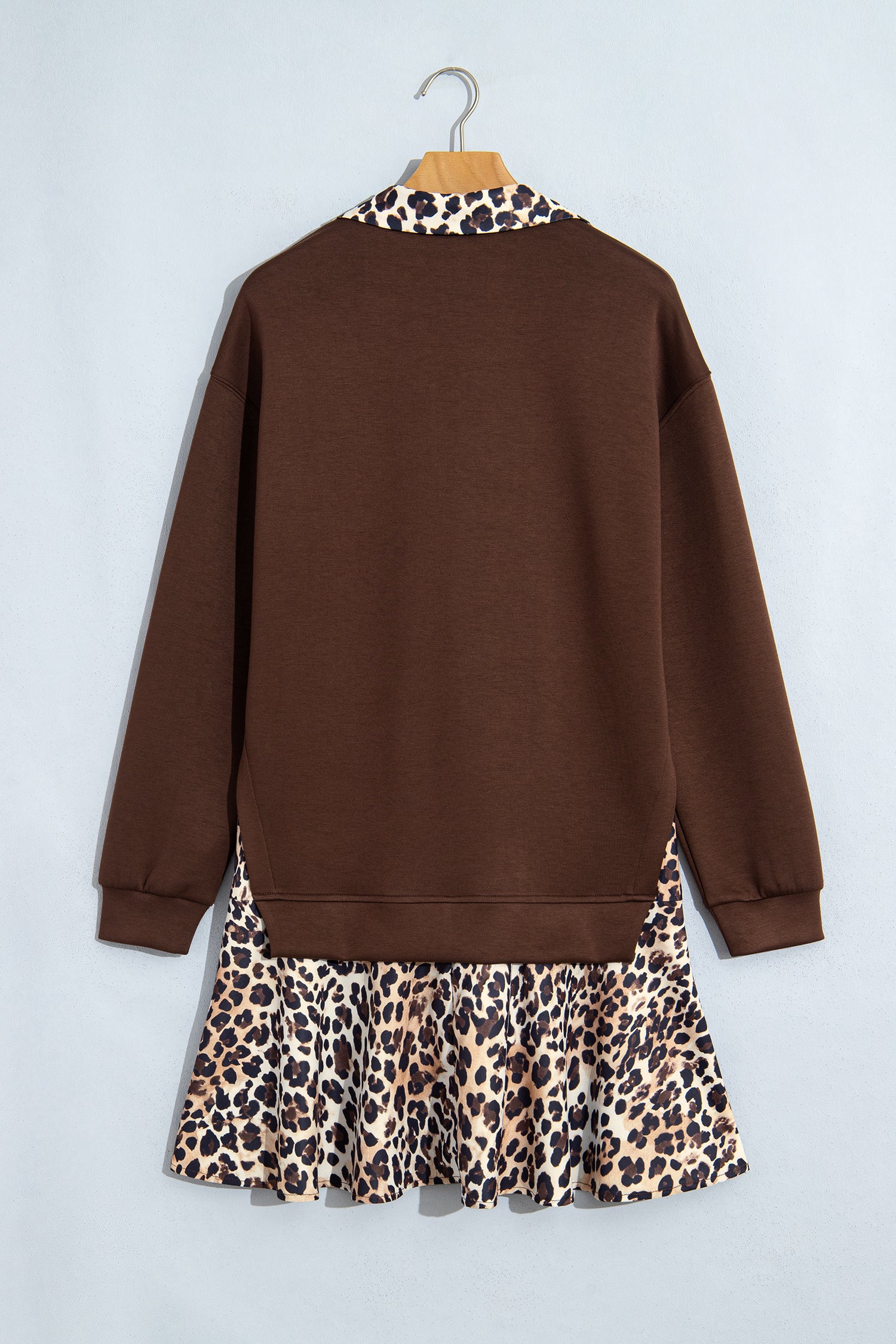 Coffee long sleeve dress with leopard ruffle hem on a hanger, back view