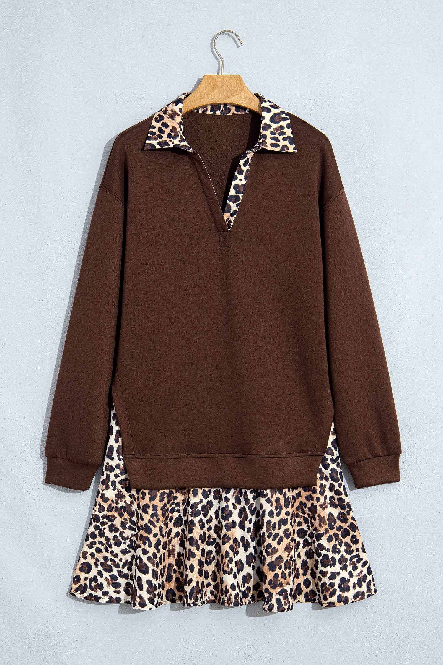 Coffee V neck dress with leopard collar and ruffle hem on a hanger, front view